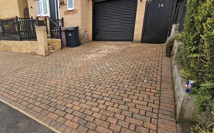 The same block paving driveway cleaned and re sanded, colour fully restored