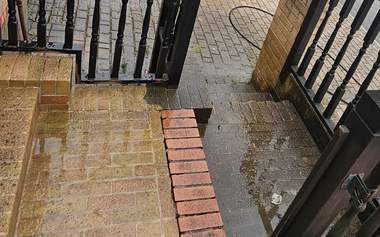 Brick paved front steps and porch dirty and slippery before cleaning