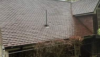 A cleaned roof with clear guttering and white fascias