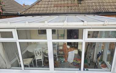 The same conservatory roof cleared of moss and debris