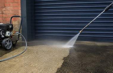 A forecourt being pressure washed