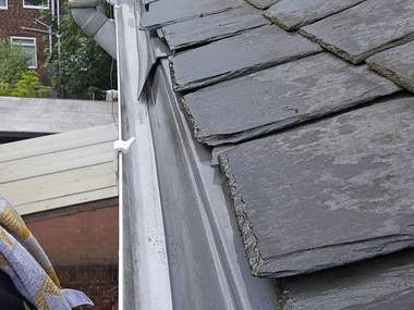A gutter cleared along the edge of a slate roof