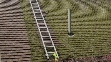 Ladder access set up for clearing a blocked gutter