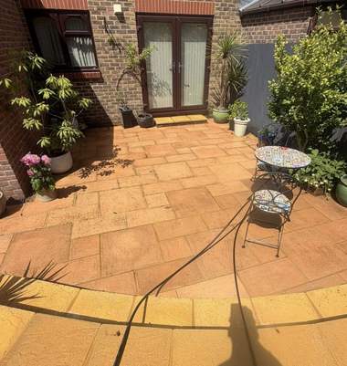 A patio cleaned back to a warm sandstone colour