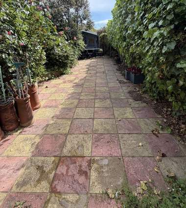 A patterned path faded and dirty before cleaning
