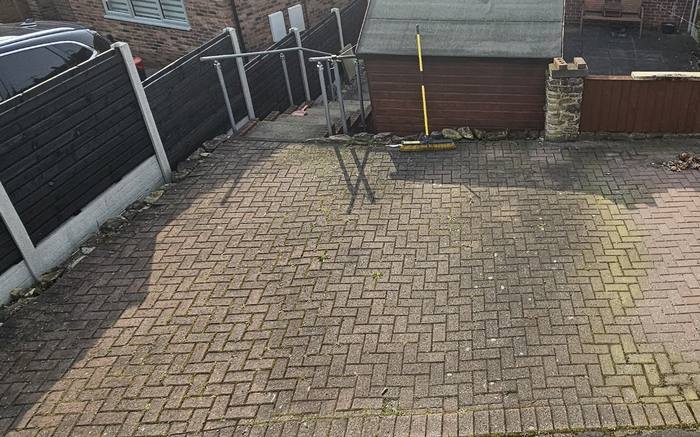 Rear yard block paving green with moss and algae before cleaning