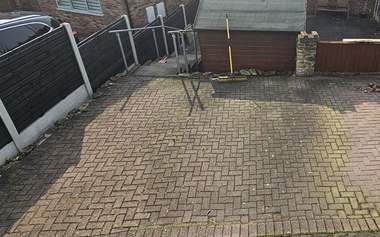 Rear yard block paving green with moss and algae before cleaning