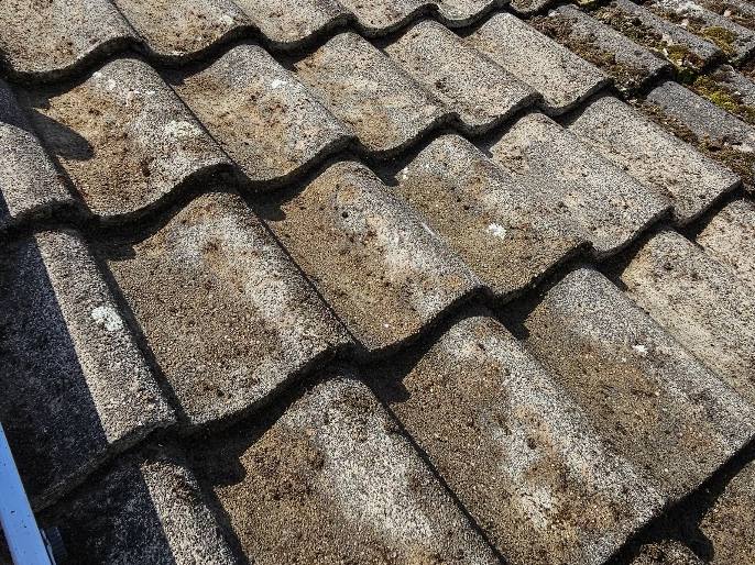 Roof tiles cleared of moss with the channels running clear again