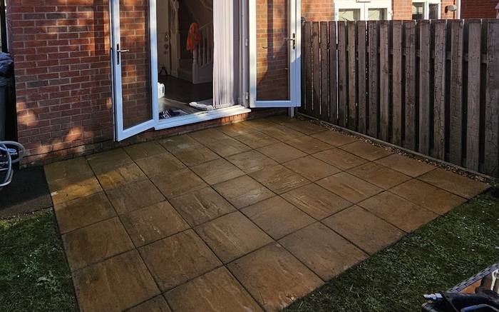 The same Indian sandstone patio cleaned back to a warm buff colour