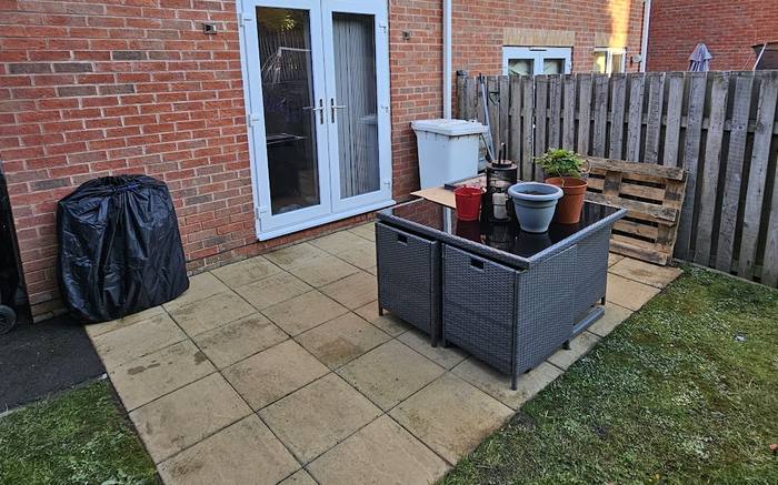 Indian sandstone patio stained grey and green before cleaning