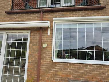 The rear of a house with every window, frame and sill cleaned